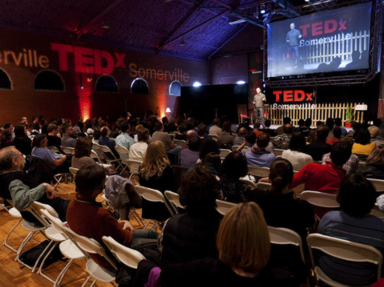 a crowd watching Michael Norton speak at TEDx Somerville